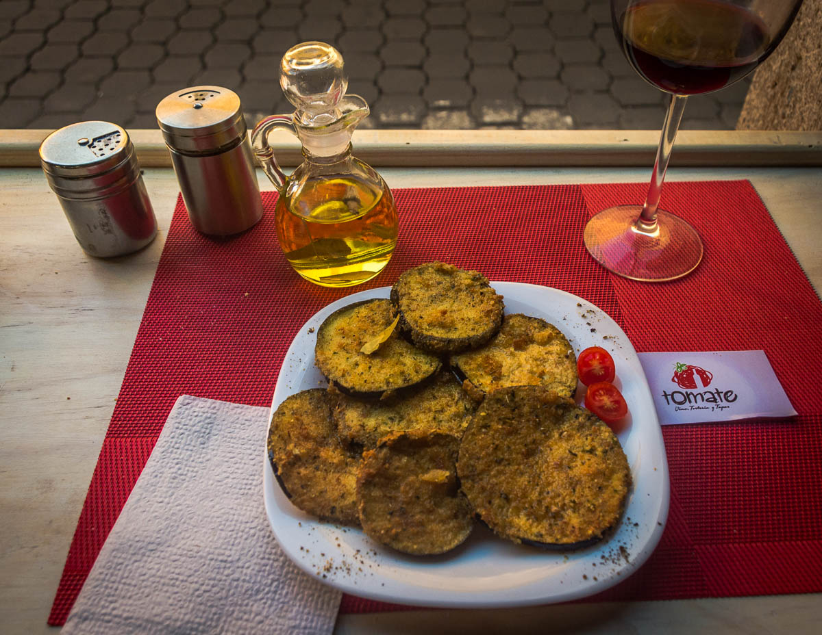 Slices of fried eggplant, crusted with parmesan